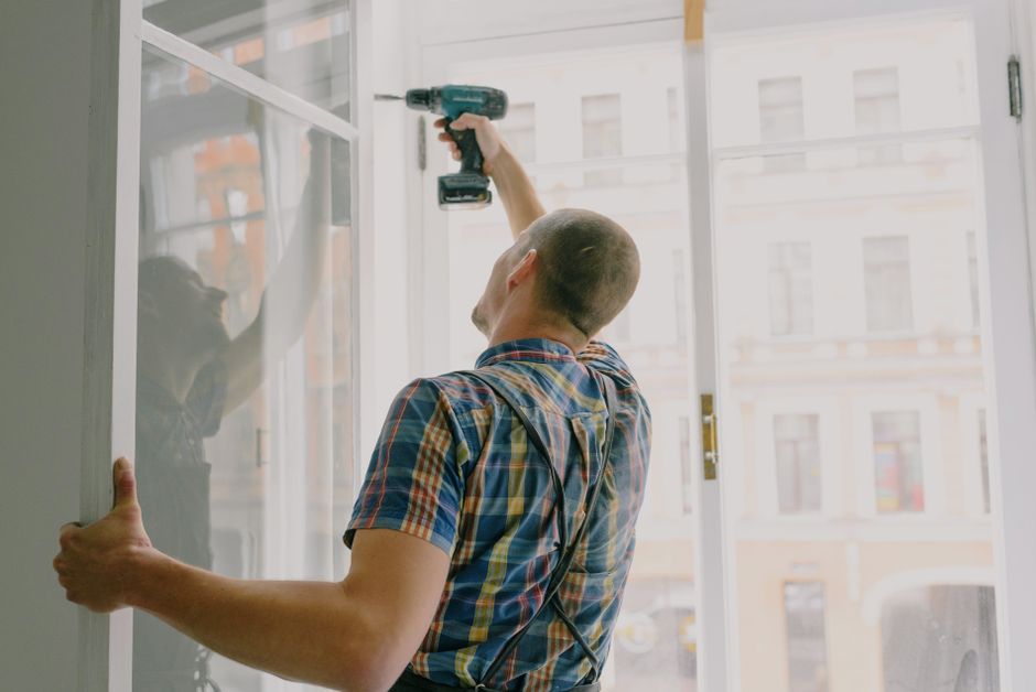 Installer fitting a window frame